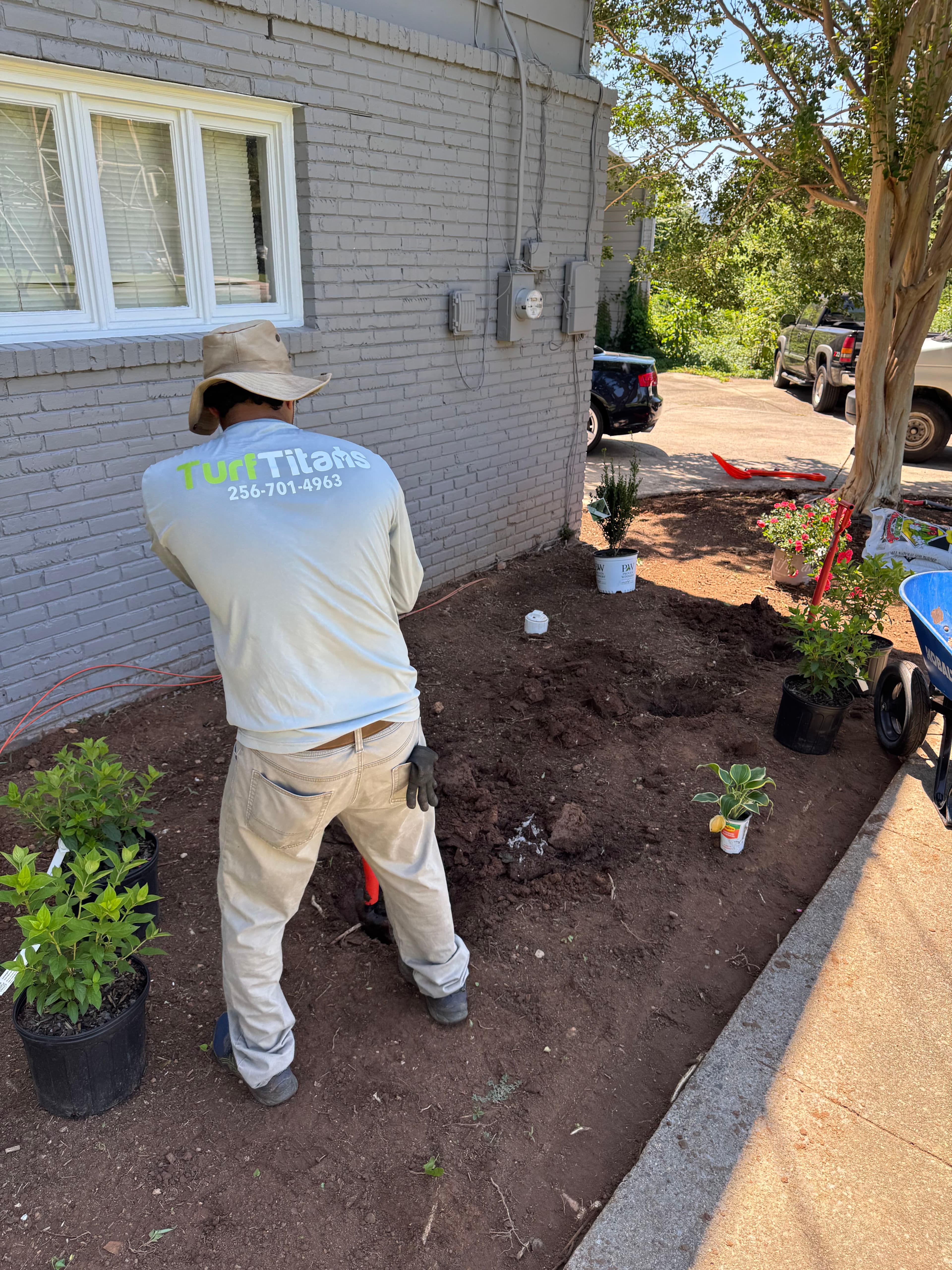 Turf Titans crew tending landscape beds at a Huntsville Alabama home